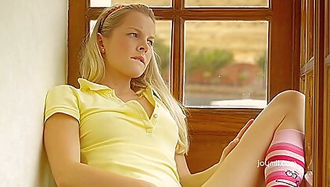 Slender blonde teen showing her beautiful face and body