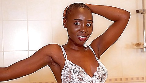 Ebony woman in pink lingerie uses vibrator and dildo