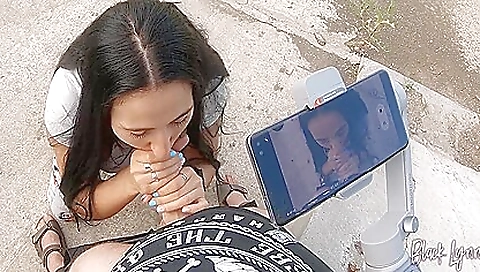 Brunette babe with a huge mouth and a big ass is filmed outdoors